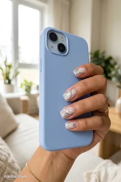 Close-up of short square nails with raised 3D chrome water drops — look 3