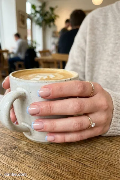 Close-up of short square nails with ultra-thin baby blue micro French tips — look 2