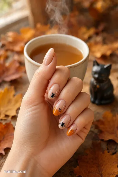 Close-up of oval nails with cute black cat silhouettes with orange accents — look 4