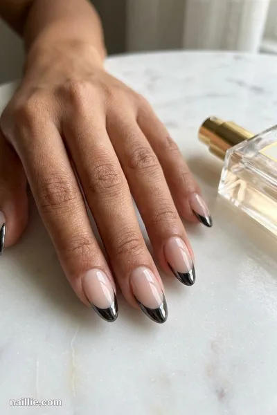 Close-up of almond nails with black chrome French tips — look 2