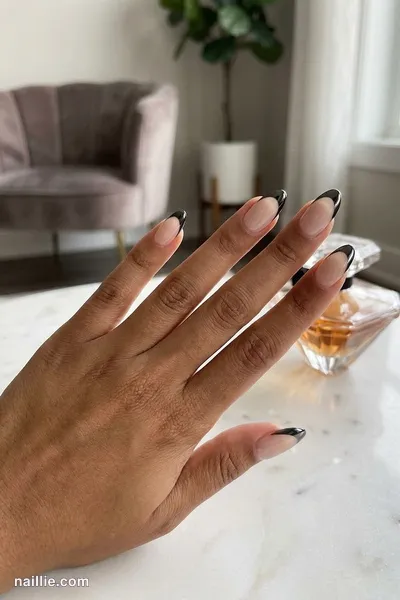 Close-up of almond nails with black chrome French tips — look 3