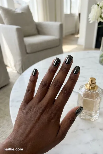 Close-up of short square nails with black polish and a mirror-like chrome finish — look 3