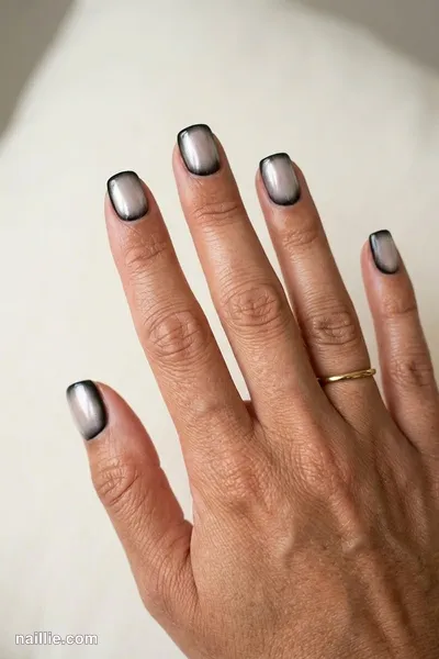 Close-up of squoval nails with black polish and a pearly glazed-donut shimmer — look 2