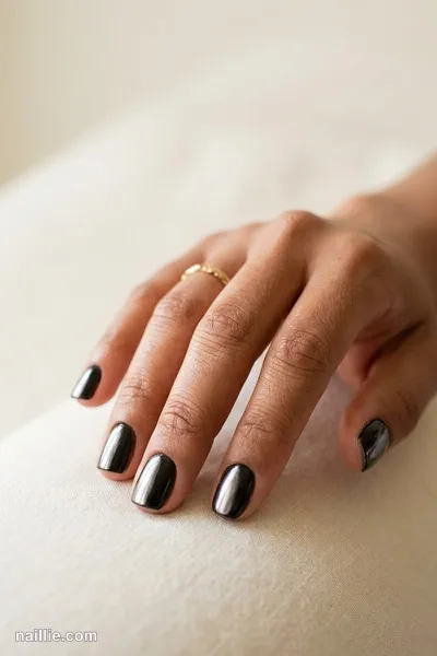 Close-up of squoval nails with black polish and a pearly glazed-donut shimmer — look 3