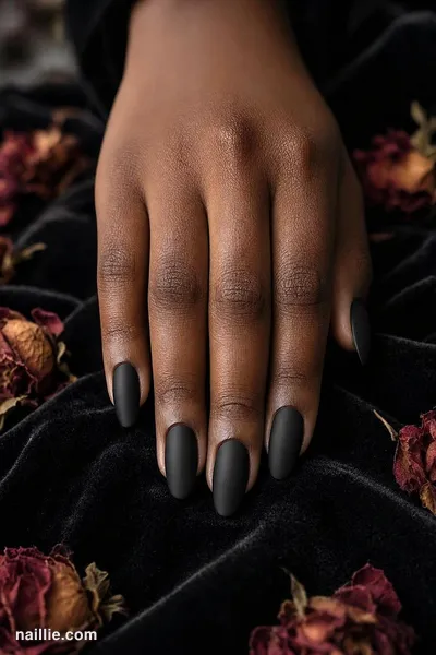 Close-up of almond nails with black polish and a soft matte top coat — look 2