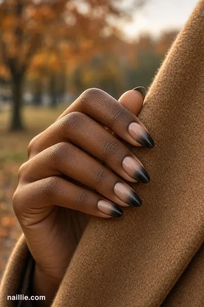 Close-up of almond nails with a black ombre fading into nude — look 2