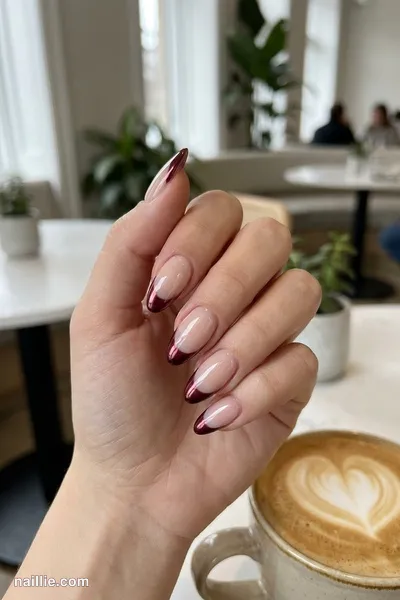 Close-up of almond nails with burgundy chrome French tips — look 3