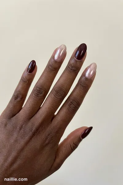 Close-up of oval nails with burgundy polish and a pearly glazed-donut shimmer — look 2