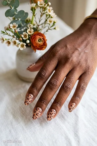 Close-up of oval nails with burnt orange leopard print spots — look 2