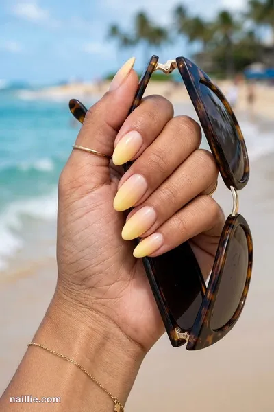 Close-up of almond nails with a butter yellow ombre fading into nude — look 2