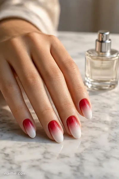 Close-up of almond nails with glossy cherry red nails mixed with milky pink ones — look 2