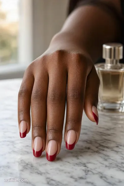 Close-up of oval nails with a cherry red double French line — look 2