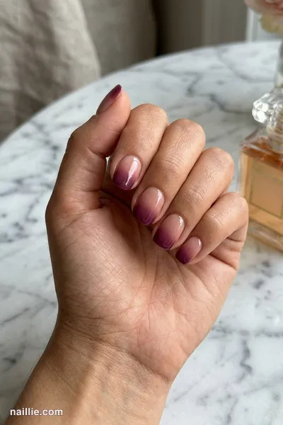 Close-up of squoval nails with a deep plum ombre fading into nude — look 2