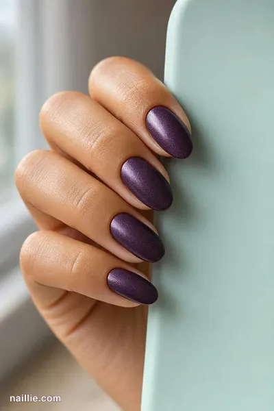 Close-up of almond nails with deep plum polish and a soft velvet shimmer — look 2