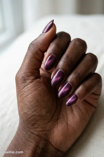 Close-up of short almond nails with deep plum polish and a soft velvet shimmer — look 3