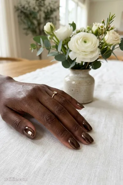 Close-up of short square nails with espresso brown polish and a mirror-like chrome finish — look 3