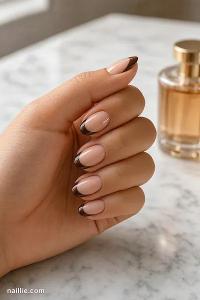 Close-up of oval nails with a espresso brown double French line — look 2