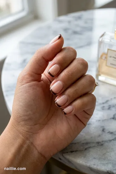 Close-up of short square nails with espresso brown French tips over a sheer nude base — look 2