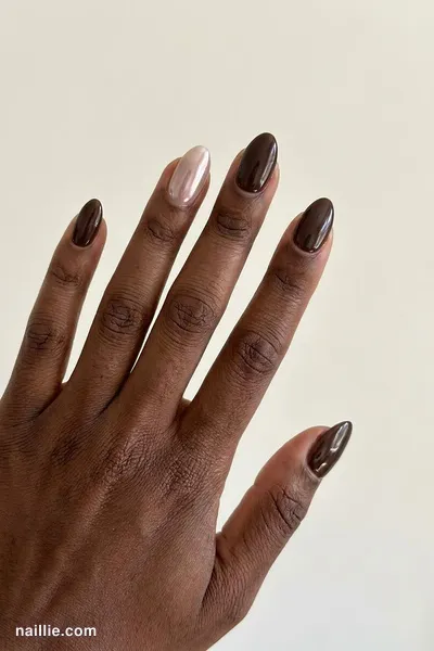 Close-up of almond nails with espresso brown polish and a pearly glazed-donut shimmer — look 2