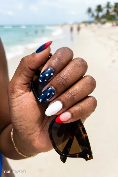 Close-up of almond nails with red, white and blue with tiny stars — look 2