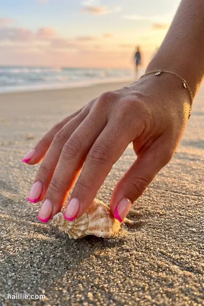 Close-up of short square nails with hot pink French tips over a sheer nude base — look 3