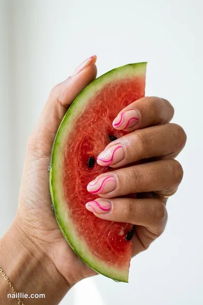Close-up of oval nails with hot pink abstract swirls on a nude base — look 3