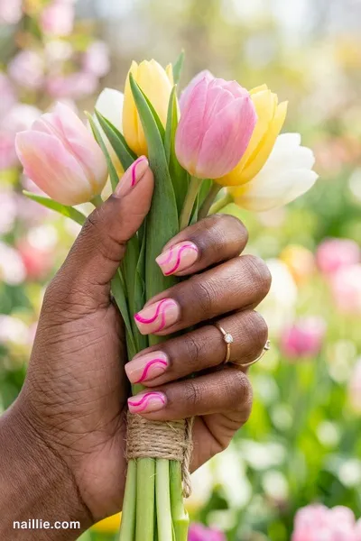Close-up of short square nails with hot pink abstract swirls on a nude base — look 2