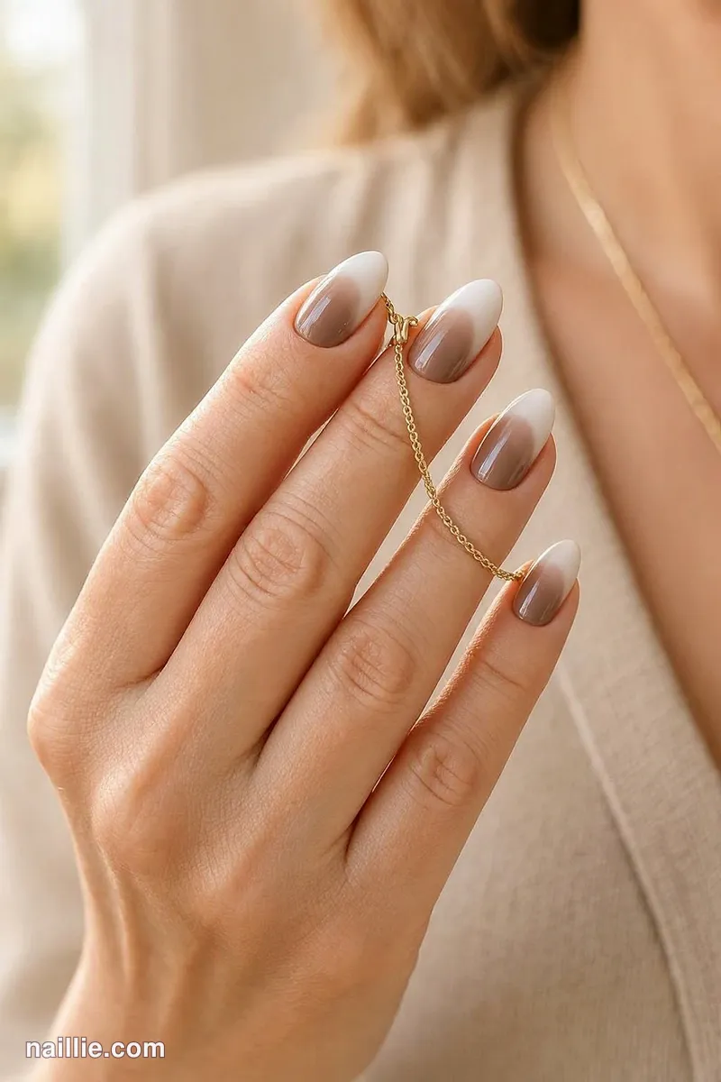 Close-up of almond nails with a soft mocha baby boomer fade