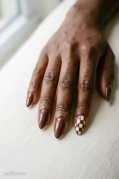 Close-up of almond nails with a mocha and cream checkerboard — look 3