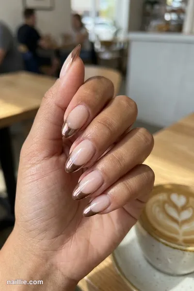Close-up of almond nails with mocha chrome French tips