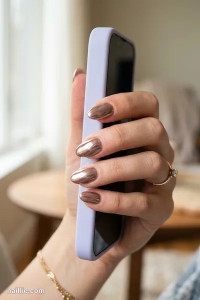 Close-up of oval nails with mocha polish and a mirror-like chrome finish — look 2