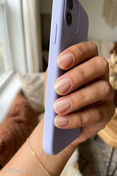 Close-up of short square nails with one fine nude beige line across a sheer base — look 2