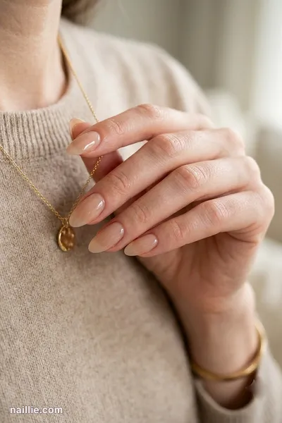 Close-up of almond nails with nude beige polish and a glossy see-through jelly finish — look 2