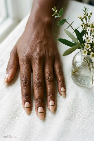 Close-up of almond nails with one fine olive green line across a sheer base — look 2