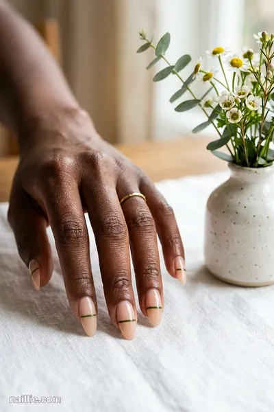 Close-up of almond nails with one fine olive green line across a sheer base — look 3