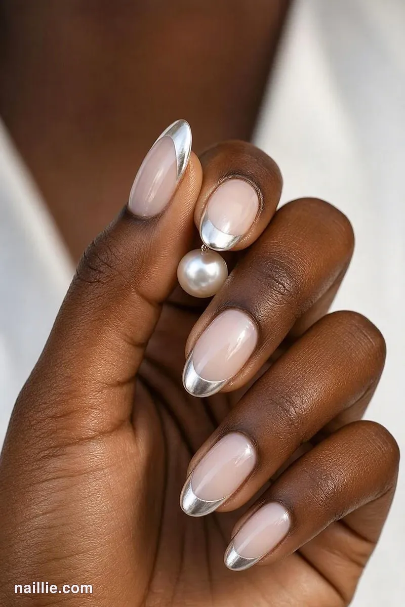 Close-up of oval nails with pearl white chrome French tips
