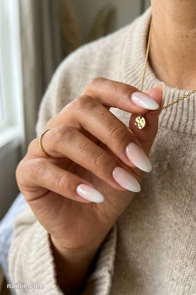 Close-up of almond nails with a pearl white ombre fading into nude — look 2