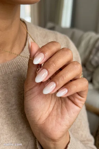 Close-up of almond nails with a pearl white ombre fading into nude — look 3