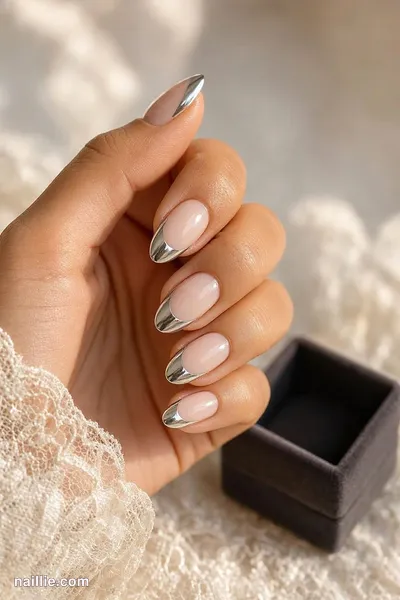 Close-up of almond nails with silver chrome French tips — look 3