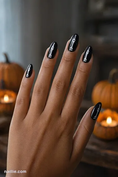 Close-up of almond nails with white skeleton bones on black