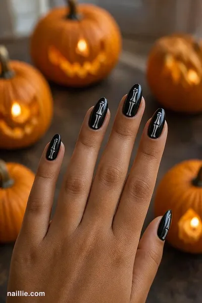 Close-up of almond nails with white skeleton bones on black — look 2