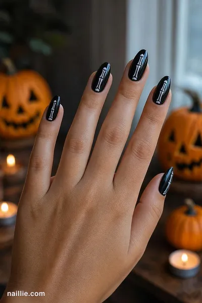 Close-up of almond nails with white skeleton bones on black — look 3