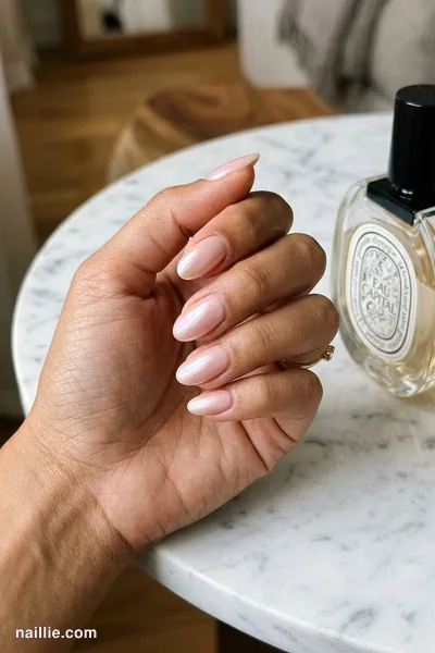 Close-up of oval nails with soft pink nude polish and a pearly glazed-donut shimmer — look 2