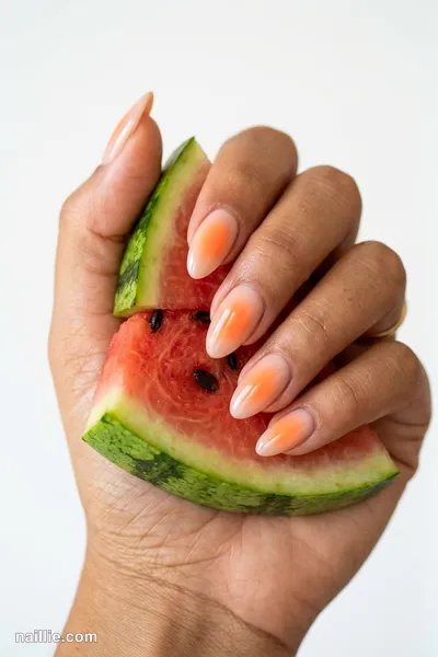 Close-up of almond nails with a glowing sunset orange aura in the center — look 2