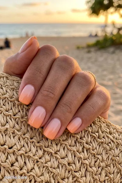 Close-up of short square nails with a sunset orange ombre fading into nude — look 3