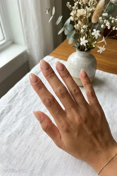 Close-up of oval nails with a single tiny taupe dot on each nail — look 3